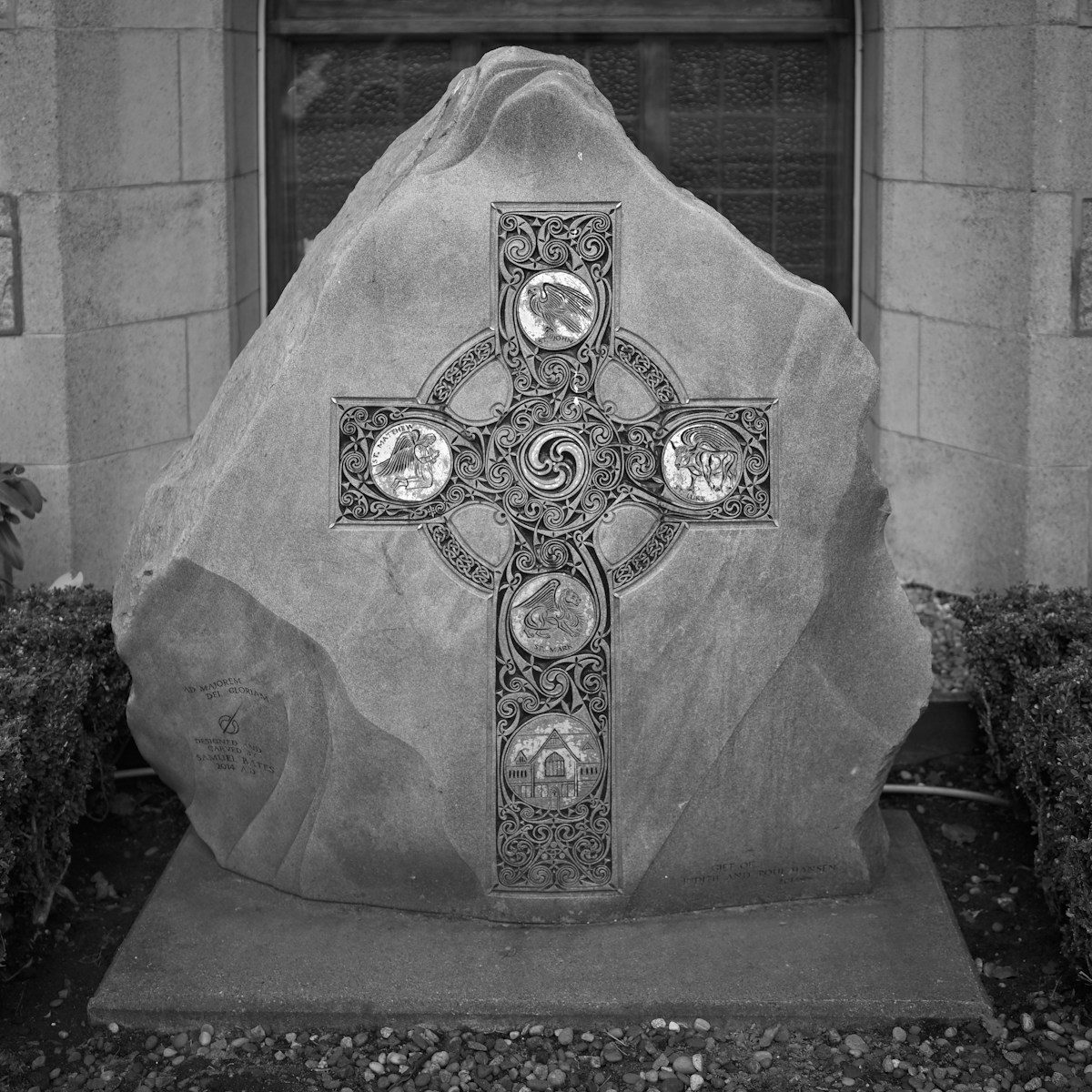 A large rock with a cross on it